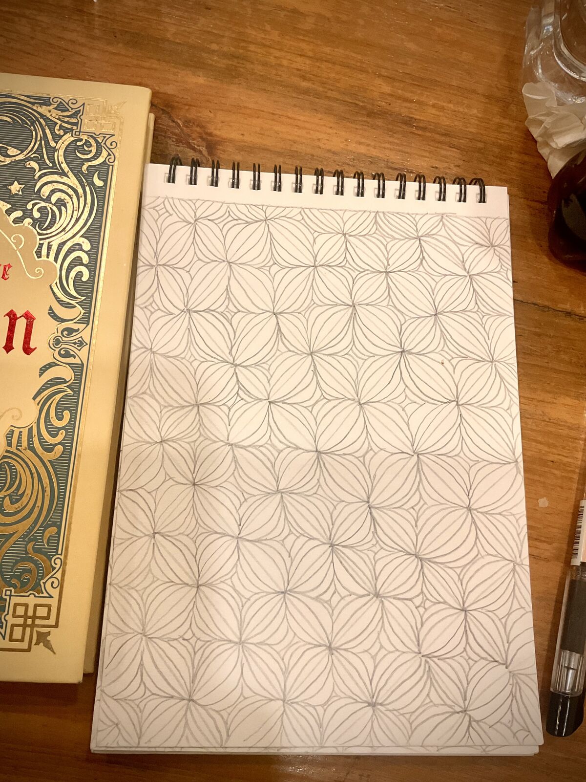 A lattice of petal shapes filling a sketchbook page