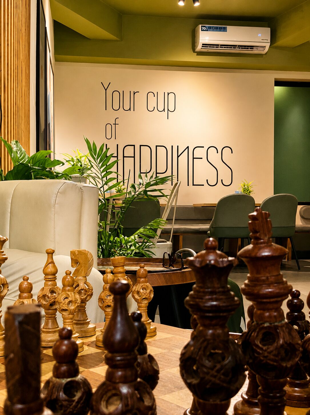 Chess pieces in the foreground at Himalayan Java, Ranipokhari, wall reading Your cup of happiness