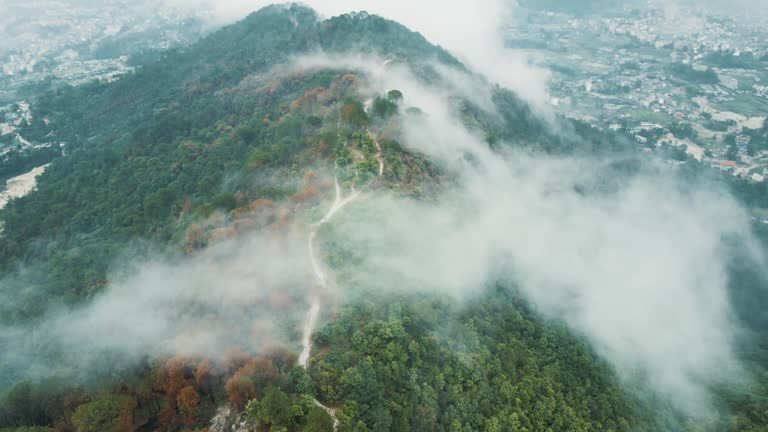 Clouds settling over green hills